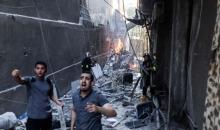 عمل أطقم الدفاع المدني في متابعة مكان القصف الإسرائيلي الذي استهدف شقة سكنية في برج فلسطين بمدينة غزة.jpg