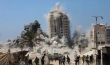 Smoke billows during Israeli strikes on tall building in Gaza City on September 5, 2025,