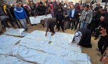 شارك فلسطينيون في جنازة 25 فلسطينياً، بينهم الصحفية هبة العبادلة، الذين فقدوا أرواحهم بعد استهداف منازلهم في غارة جوية إسرائيلية، ثم انتشالهم لاحقاً من تحت الأنقاض، في خان يونس، جنوب قطاع غزة، في 26 ديسمبر/كانون الأول 2025. (صورة: طارق محمد)