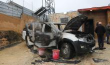 فلسطينيون يقفون في موقع حريق سيارة أشعله مستوطنون إسرائيليون في بلدة حوارة، جنوب نابلس في الضفة الغربية، 28 ديسمبر/كانون الأول 2025. صورة: محمد ناصر