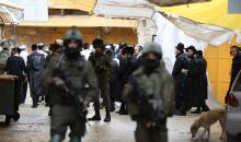 جنود إسرائيليون يقفون في دورية حراسة خلال جولة أسبوعية للمستوطنين في مدينة الخليل، جنوب الضفة الغربية ، 10 يناير/كانون الثاني 2026. تصوير: مأمون وزواز