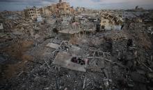 عائلة فلسطينية تتناول إفطارها خلال شهر رمضان على سطح منزلها الذي دمره قصف جوي إسرائيلي خلال حرب غزة في 27 فبراير/شباط 2026. صورة: عمر أشتوي