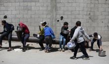 إحدى الجمعيات الخيرية توزع وجبات طعام على الفلسطينيين النازحين في مخيم النصيرات للاجئين، في ظل استمرار نقص الغذاء نتيجةً للسياسة الإسرائيلية المتعلقة بدخول المساعدات إلى قطاع غزة، في 11 أبريل/نيسان 2026. (تصوير: حسن جيدي)