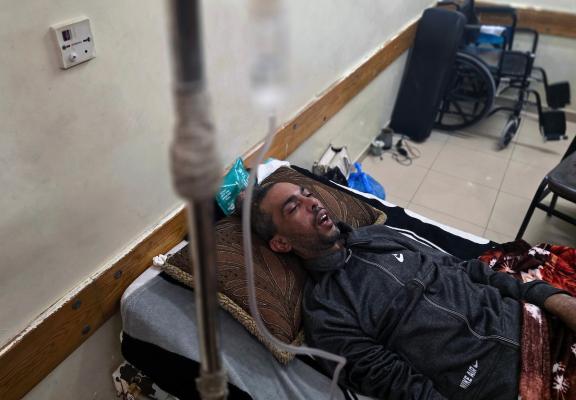 الشاب رائد المريدي يرقد على سرير العلاج في مستشفى ناصر بخان يونس في انتظار السفر خارج قطاع غزة لاستكمال العلاج، بعد إصابته بشلل رباعي جراء قصف إسرائيلي،  13 أبريل/نيسان 2026.(صورة: طارق محمد)