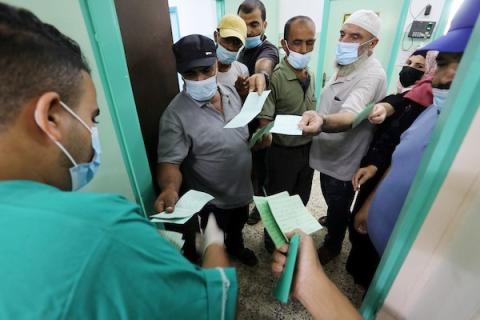     فلسطينيون يتلقون جرعات لقاح ضد فايروس كورونا في دير البلح وسط قطاع غزة