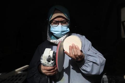 سيدات فلسطينيات يُبدعن بصنع الهدايا الخشبية في منجرة متواضعة تابعة لجمعية زين التعاونية في بيت لاهيا شمال قطاع غزة، لبيعها بيوم المرأة العالمي