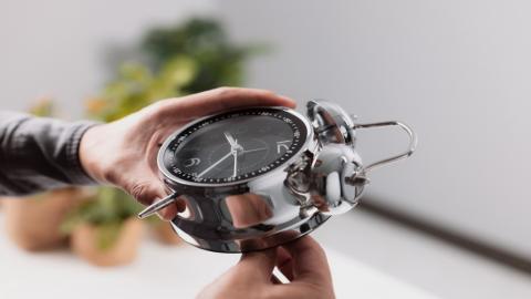 صورة توضيحية لشخص يعدّل الوقت على الساعة. (shutterstock).jpeg