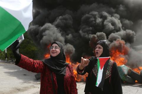 فلسطينيات يشاركن في مسيرة في اليوم العالمي للمرأة على مدخل قرية برقة غرب مدينة نابلس