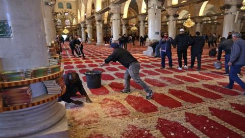 مصلون يزيلون أضرارا بعد الاعتداءات الإسرائيلية على المسجد الأقصى. (أ ف ب).jpeg