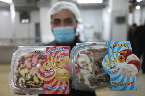 عشرات العمال الفلسطينيين في مصنع العريس لإنتاج المثلجات في خان يونس جنوب قطاع غزة