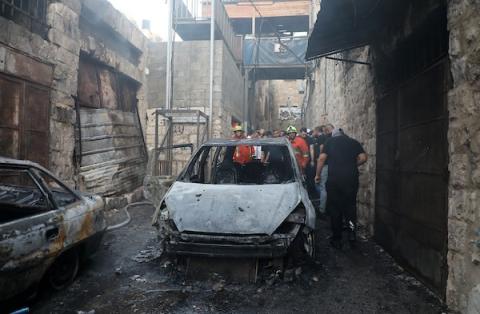 مواطنون يتفقدون منزلاً مدمراً في احياء البلدة القديمة جراء العدوان الاسرائيلي فجر اليوم.jpg