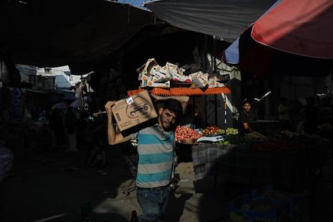 فلسطينيون يتسوقون من أحد أسواق مدينة غزة بعد عودة الحياة إلى طبيعتها وتوقف العدوان الإسرائيلي