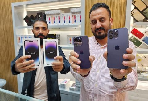 تاجر فلسطيني يستعرض هاتف آيفون 14 برو ماكس داخل محله بعد وصوله إلى قطاع غزة في مدينة خانيونس 7.jpg