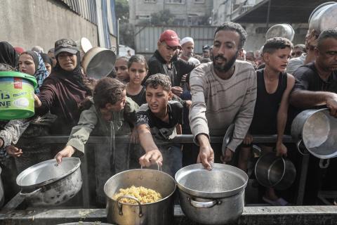 طوابير طويلة للحصول على وجبات ساخنة توزعها جمعيات خيرية في قطاع غزة.  تصوير: معز صالحي