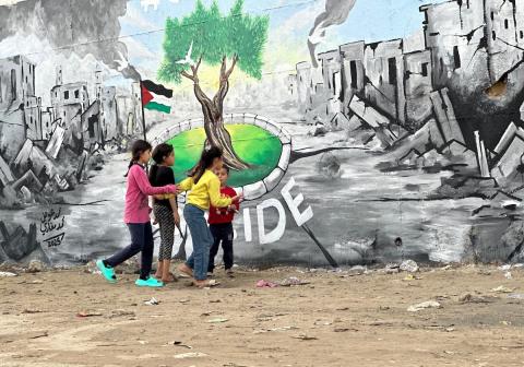 يرسم فنانون فلسطينيون جدارية وسط أنقاض المباني المدمرة في خان يونس، جنوب قطاع غزة.jpg