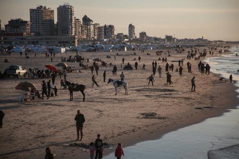 يقضي الفلسطينيون أوقاتهم على شاطئ البحر ​​عند غروب الشمس في مدينة غزة. في الوقت نفسه، تحوّل شاطئ القطاع إلى مخيم مؤقت للنازحين الذين دُمّرت منازلهم خلال الحرب. 16 يناير/كانون الثاني 2026. تصوير: عمر أشتوي