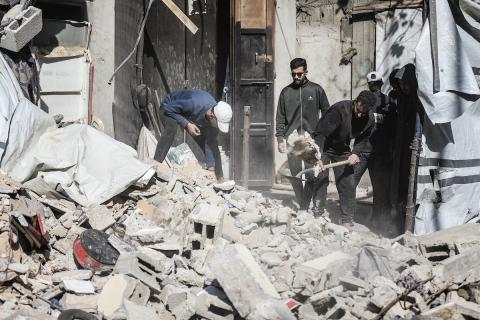 فلسطينيون يتفقدون منزلاً (تضرر سابقاً جراء غارة جوية إسرائيلية) انهار على سكانه، ما أسفر عن مقتل رجل وابنه الصغير في مخيم المغازي للاجئين وسط قطاع غزة، 5 يناير/كانون الثاني 2026. صورة: رمزي أبو عامر
