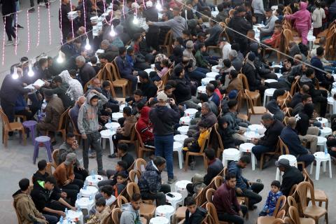 فعالية نظمتها "جمعية الإغاثة" لإفطار الفلسطينيين المقيمين في مخيم النازحين المقام بين أنقاض المباني المدمرة في مخيم جباليا، شمال قطاع غزة، في 18 فبراير/شباط 2026. (صورة: عمر أشتوي)