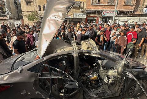 فلسطينيون يتجمعون في موقع غارة جوية إسرائيلية استهدفت مركبة في شارع الشهداء بمدينة غزة، يوم 19 مايو/أيار 2026، وأسفرت، بحسب مصادر محلية، عن استشهاد شخص وإصابة آخرين. تصوير: عمر أشتوي