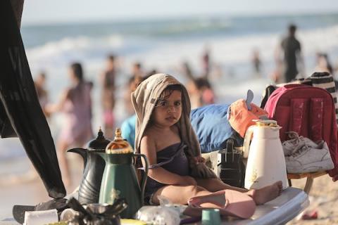 فلسطينيون يقضون بعض الوقت على شاطئ مخيم النصيرات وسط قطاع غزة، بحثًا عن ملاذ من موجة الحر الشديدة وتدهور أوضاع النزوح، في 25 يونيو/ حزيران 2026. تصوير: معز صالحي