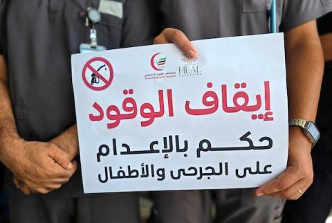 أطباء وممرضون يقفون خارج أقسام مستشفى الكويت الميداني التخصصي في قطاع غزة، في 20 سبتمبر/أيلول 2026، بعد إعلان تعليق العمل واستقبال المرضى بسبب انقطاع إمدادات الوقود. (صورة: طارق محمد)