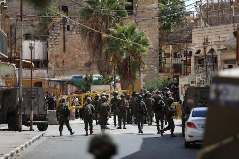 يقيّد الجنود الإسرائيليون حركة الفلسطينيين ويتخذون إجراءات أمنية خلال جولة قام بها مستوطنون في البلدة القديمة بالخليل، في 3 أكتوبر/تشرين الأول 2026. تصوير مأمون وزواز