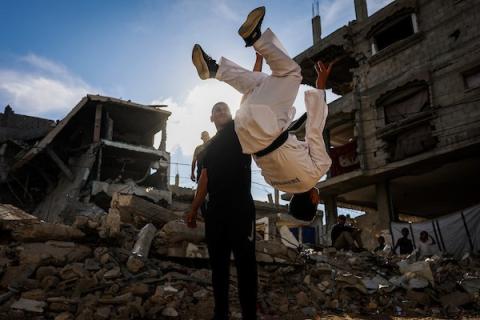 أطفال فلسطينيون يتدربون على رياضة التايكوندو بالقرب من مبنى مدمر في مخيم النصيرات وسط قطاع غزة، في 8 أكتوبر/تشرين الأول 2026، متحدين نقص المرافق الرياضية والدمار الذي طال الملاعب والمنشآت خلال ثلاث سنوات من الحرب الإسرائيلية. تصوير: بلال أسامة