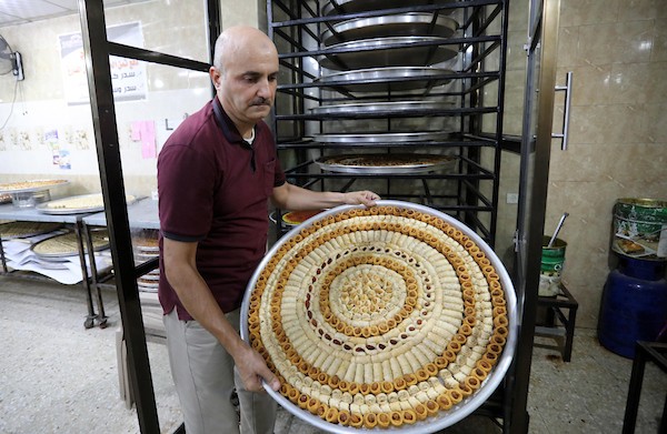 بائعون فلسطينيون يحضرون الحلويات في قطاع غزة استعدادا لإعلان نتائج الثانوية العامة التوجيهي في فلسطين لعام 2021