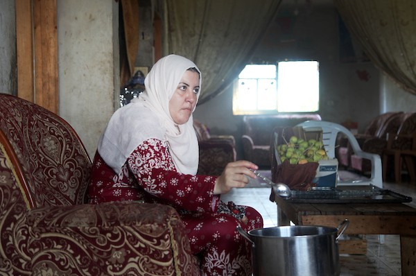 الفلسطينية حنان حمد ، 50 عاما ، تصنع حلوى التفاح بالعسل الملون المعروف في غزة باسم 