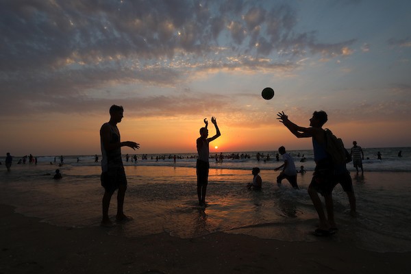 فلسطينيون يستمتعون بأوقاتهم على شاطئ البحر في مدينة دير البلح وسط قطاع غزة. 32