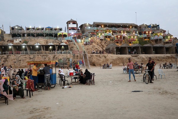 فلسطينيون يستمتعون بأوقاتهم على شاطئ البحر في مدينة دير البلح وسط قطاع غزة. 19