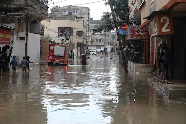 الدفاع المدني الفلسطيني ينتشل سكان من شارع غمرته مياه الأمطار ، في مخيم جباليا للاجئين الفلسطينيين شمال قطاع غزة 