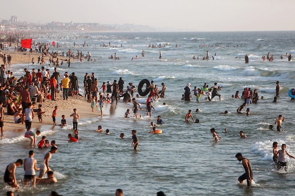 المواطنون الفلسطينيون يصطافون على شاطئ بحر مدينة غزة خلال يوم العطلة 18.jpg