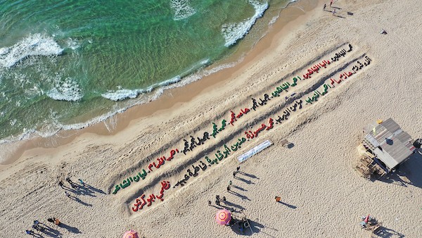 صور جوية لمنحوتة رملية على شاطئ غزة تحمل أسماء الشهداء الأطفال 4.JPG