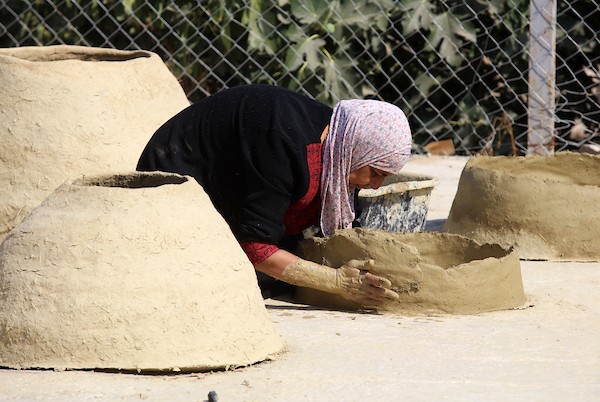 استغلت الفلسطينية آمنة صلاح سطح منزلها لتصنع أفران الطين القديمة بشكل تقليدي، استعداداً لبيعها بالأسواق المحلية في بيت لحم. 13.jpg