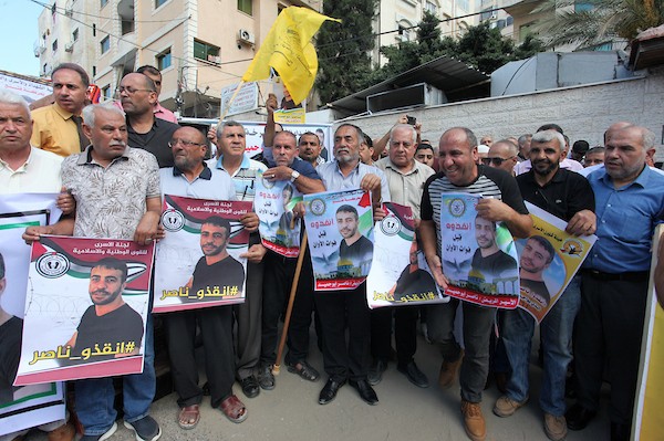 فلسطينيون يشاركون في وقفة تضامنية مع الأسير ناصر أبو حميد في مدينة غزة 7.jpg