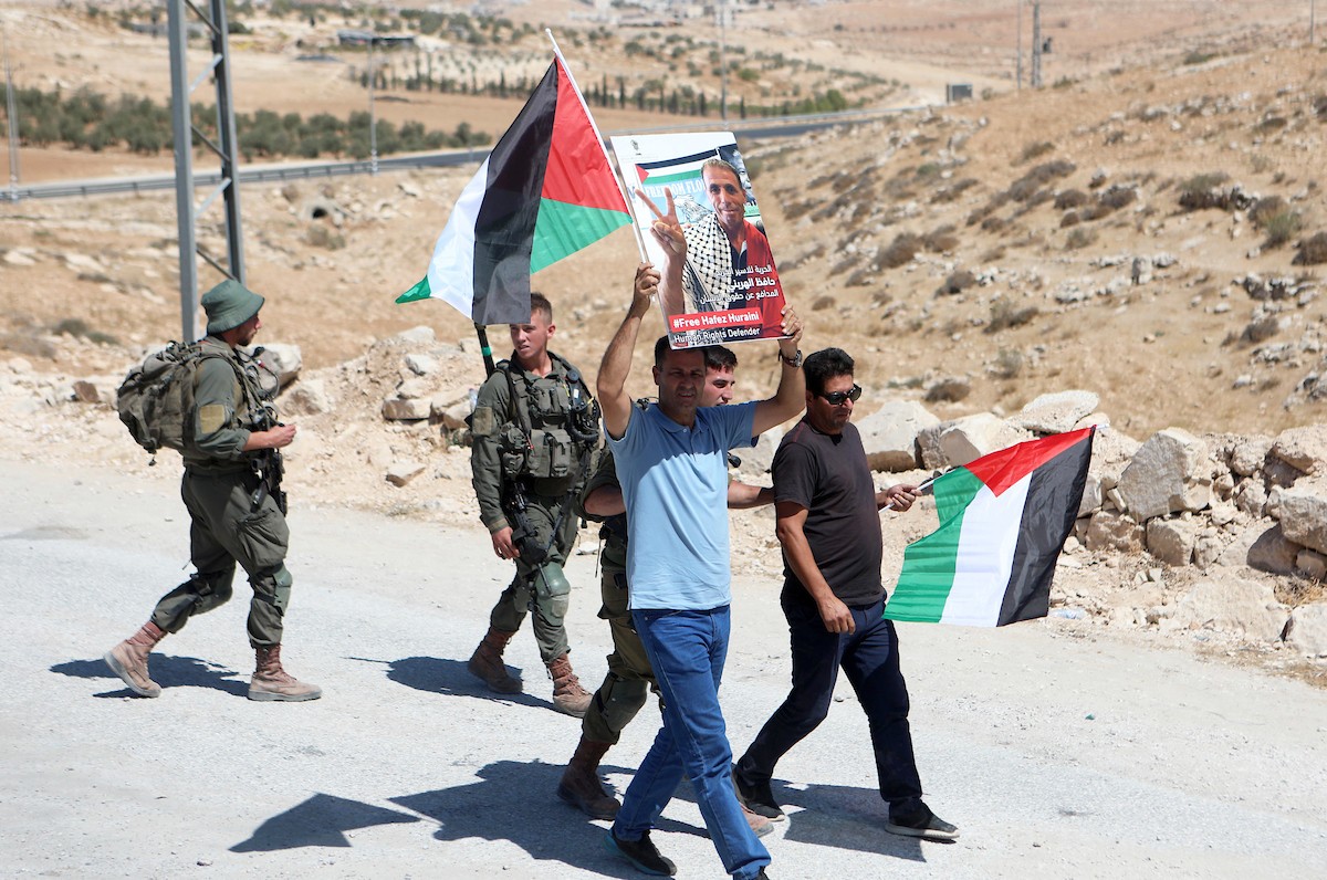 فلسطينيون يشاركون في مسيرة ضد الاستيطان في قرية يطا جنوب مدينة الخليل 14(1).jpg