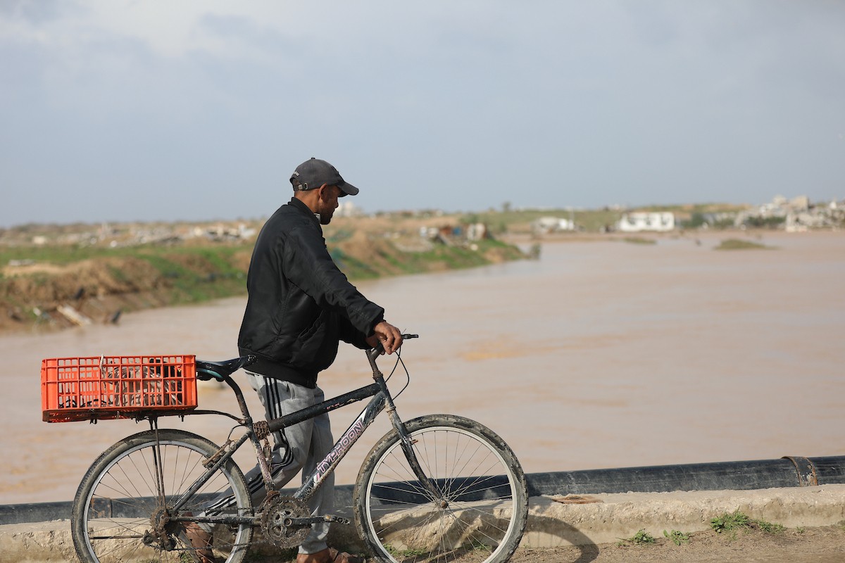 فتح الجيش الإسرائيلي مجرى وادي غزة، مما أدى إلى ارتفاع منسوب المياه إلى مستوى الجسر. وقد فاقم هذا الوضع معاناة العائلات النازحة التي كانت تقيم في خيام بالمنطقة بعد أن فاض الوادي وجرف خيامها، 29 ديسمبر/كانون الأول 2025. صورة: رمزي أبو عامر
