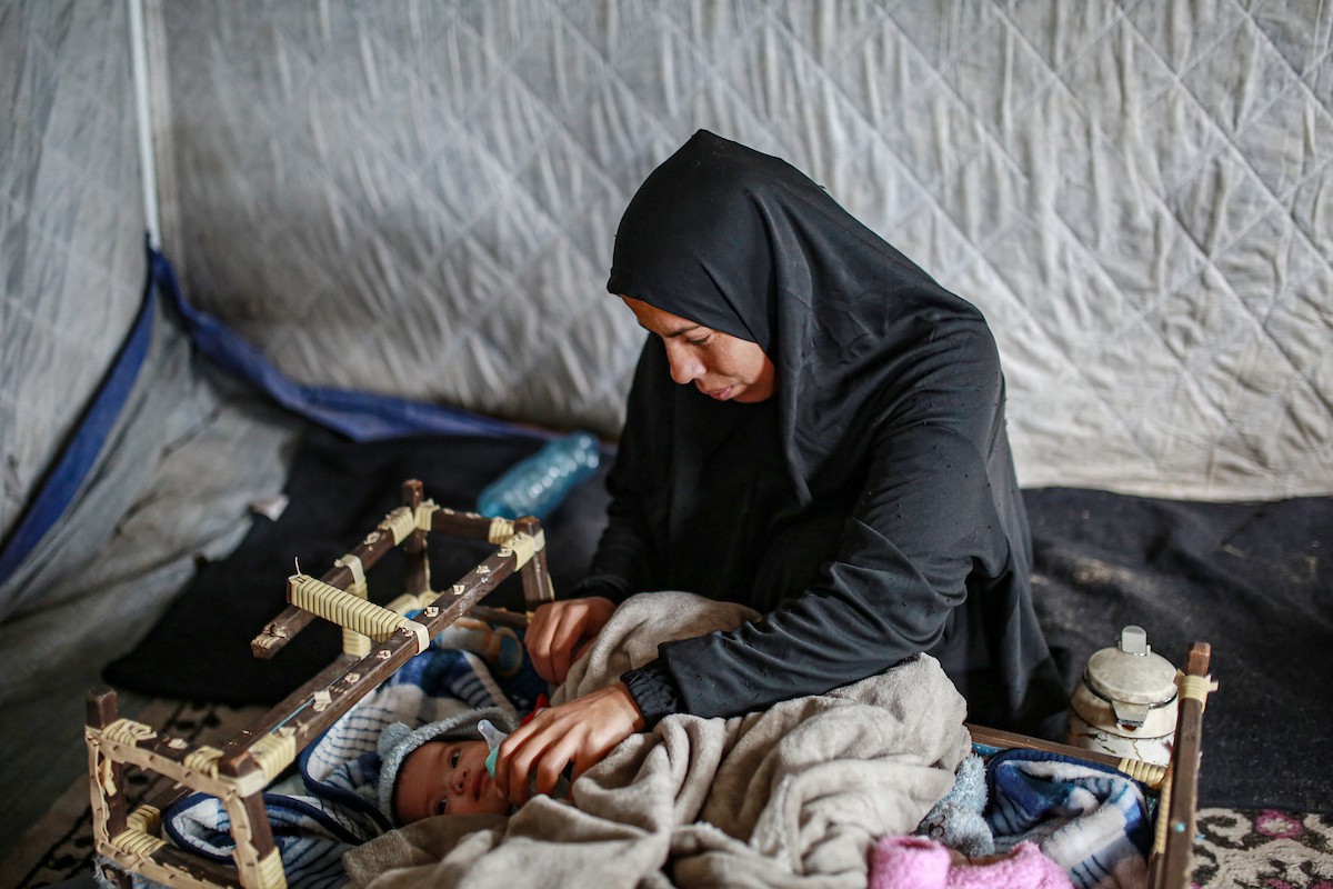 عائلة فلسطينية نازحة مكونة من ستة أفراد  تكافح وسط ظروف غير إنسانية من أجل حماية أطفالها من أجواء الشتاء القارس في  خيمة مهترئة بملعب اليرموك في مدينة غزة، 29 ديسمبر/كانون الأول 2025 صورة: عمر أشتوي