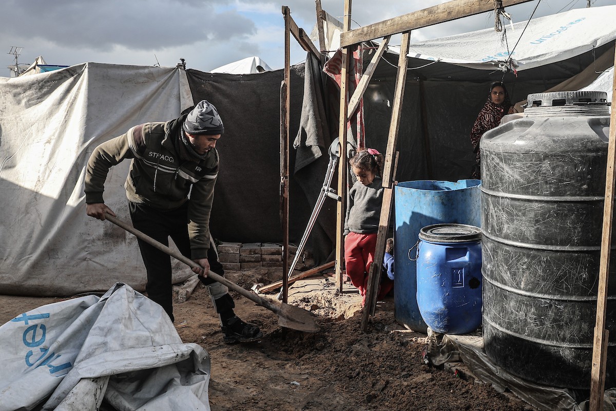 أحمد أبو ليلى أب لخمسة أطفال أصيب في الحرب  يحاول إصلاح خيمته بعد أن تضررت جراء الأمطار الغزيرة والرياح العاتية التي اجتاحت مخيم النصيرات وسط قطاع غزة، 28 ديسمبر/كانون الأول 2025.تصوير: معز صالحي