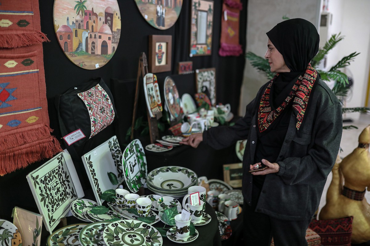 فلسطينيون يحضرون معرضًا يعرض منتجات يدوية من صنع مجموعة من الحرفيين الصم في مدينة غزة