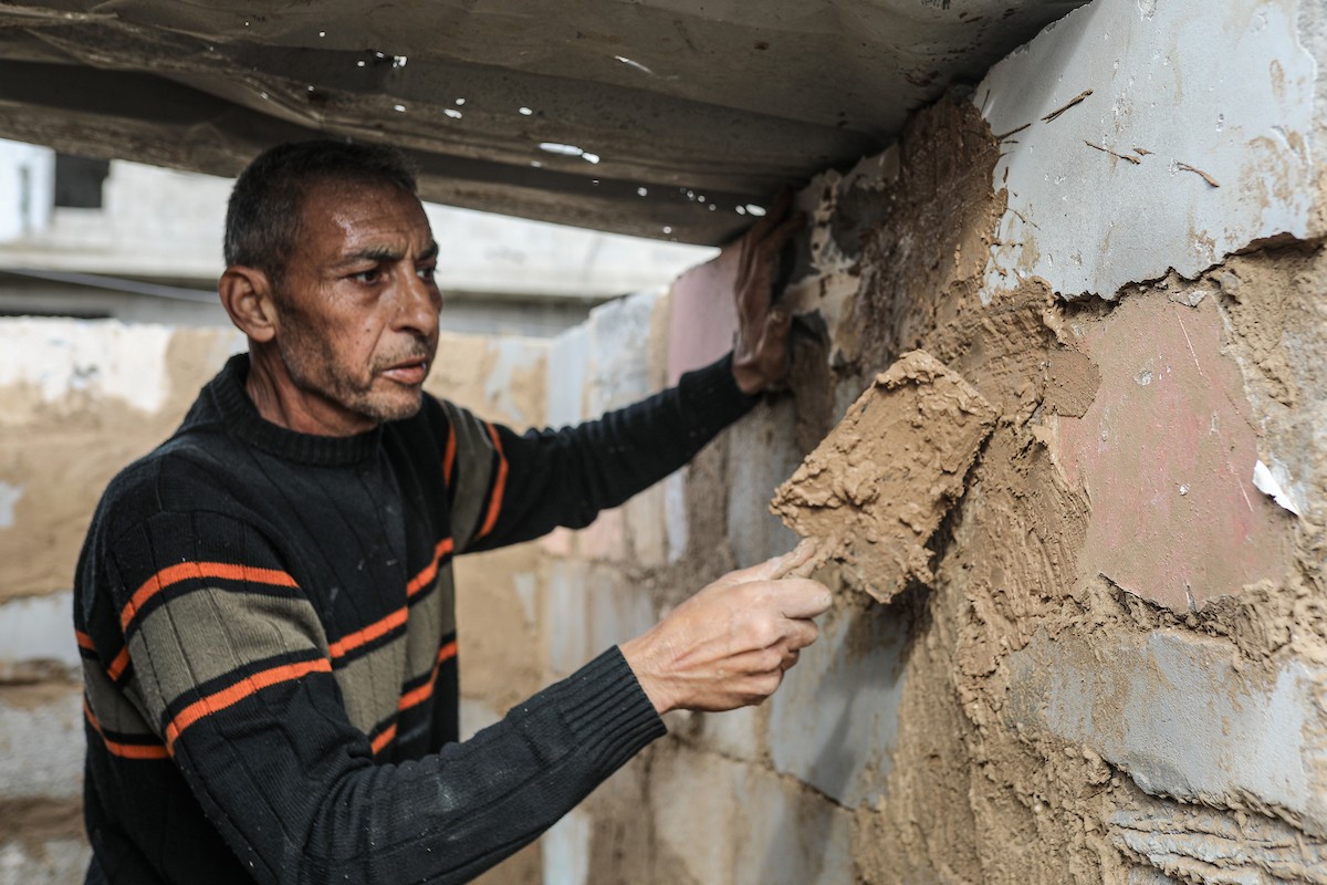 الفلسطيني أحمد المبحوح، مريض سرطان، يبني منزلاً طينياً بيديه في مخيم البريج للاجئين وسط قطاع غزة، 15 ديسمبر/كانون الأول 2025. عدسة: رمزي أبو عامر