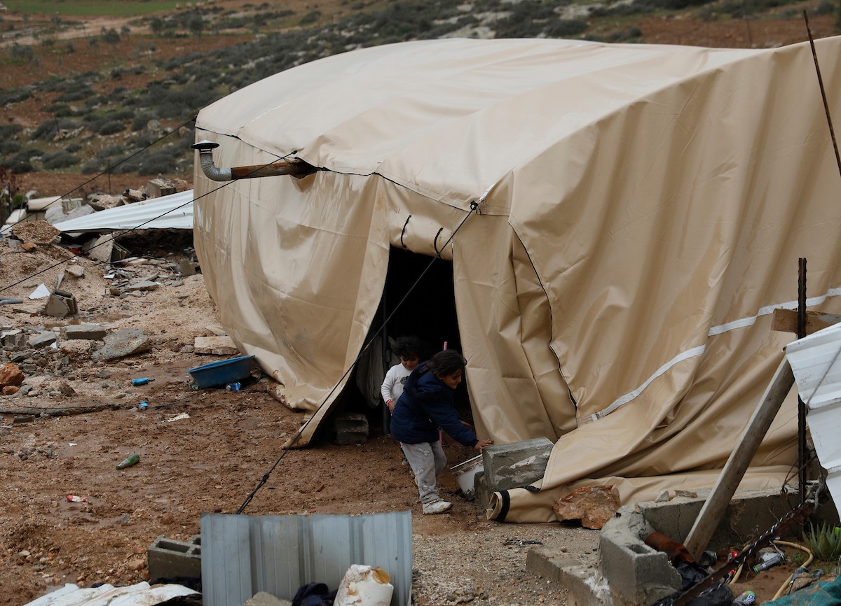 مياه الأمطار تغمر خيمة عائلة حرب التي أقامتها على أنقاض منزلهم الذي هدمه الجيش الإسرائيلي في 9 ديسمبر، في منطقة خلات الفرا، غرب يطا، جنوب الخليل، 29 ديسمبر/كانون الأول 2025. تصوير: مأمون وزواز