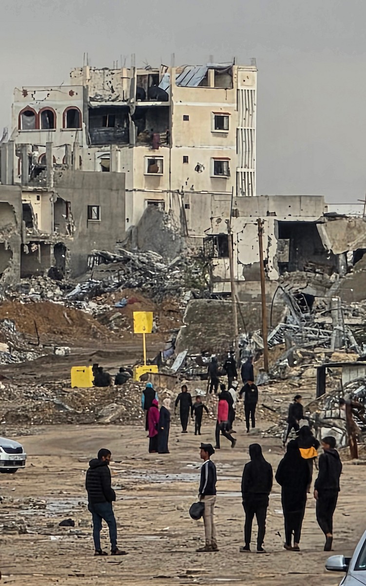 عائلة فلسطينية تحتمي من برد الشتاء القارس في خيمة نصبتها فوق منزلها المدمر قرب الخط الأصفر في خان يونس، جنوب قطاع غزة، ١٧ ديسمبر/كانون الأول ٢٠٢٥. تصوير: طارق محمد/وكالة الأنباء الفلسطينية (APA )