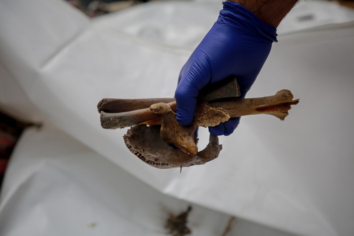 عمال الدفاع المدني الفلسطيني يبحثون عن جثث في مبنى منهار يعود لعائلة سالم، استُهدف بغارات إسرائيلية في بداية الحرب، في شارع الجلاء بمدينة غزة، يوم الاثنين 15 ديسمبر/كانون الأول 2025. صورة: عمر أشتوي