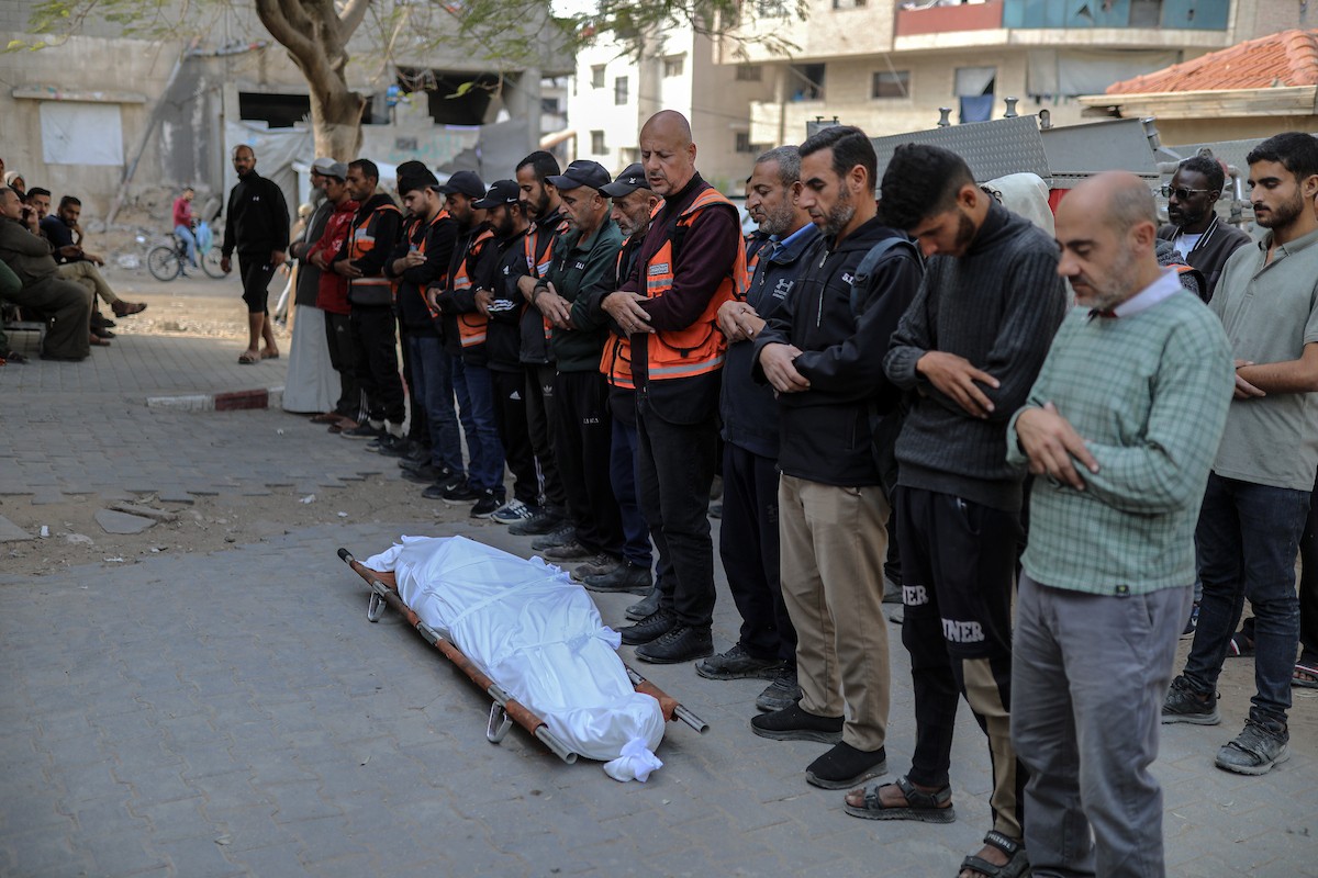فلسطينيون ينعون ويحملون جثامين عدد من القتلى في غارة إسرائيلية على بيت لاهيا، بينهم أحد عناصر الدفاع المدني، خلال جنازة في مستشفى الشفاء بمدينة غزة