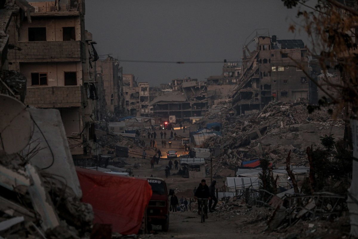 يعيش الفلسطينيون حياتهم اليومية ليلاً في خيام نصبت فوق أنقاض المباني المدمرة في حي الشيخ رضوان وسط مدينة غزة، 5 ديسمبر/كانون الأول 2025.تصوير: عمر أشتوي