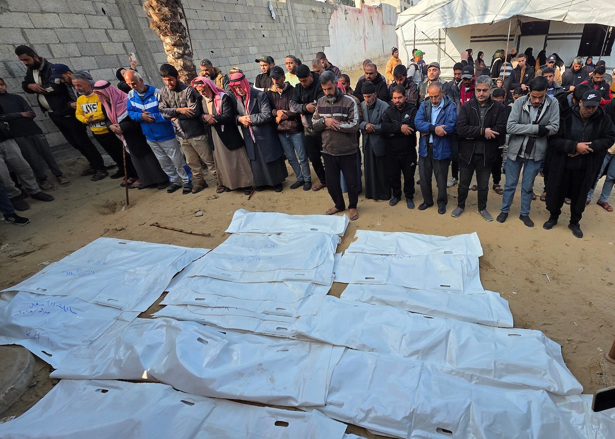 شارك فلسطينيون في جنازة 25 فلسطينياً، بينهم الصحفية هبة العبادلة، الذين فقدوا أرواحهم بعد استهداف منازلهم في غارة جوية إسرائيلية، ثم انتشالهم لاحقاً من تحت الأنقاض، في خان يونس، جنوب قطاع غزة، في 26 ديسمبر/كانون الأول 2025. (صورة: طارق محمد)