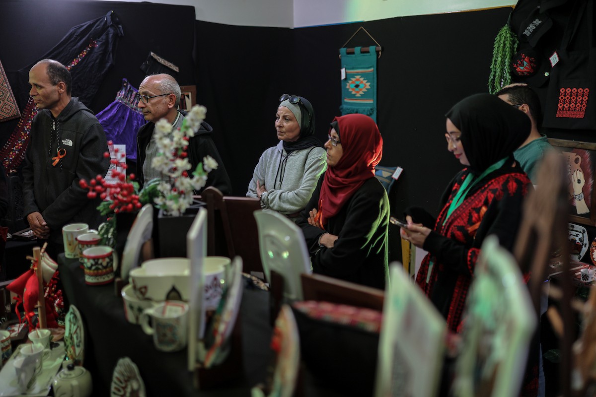 فلسطينيون يحضرون معرضًا يعرض منتجات يدوية من صنع مجموعة من الحرفيين الصم في مدينة غزة