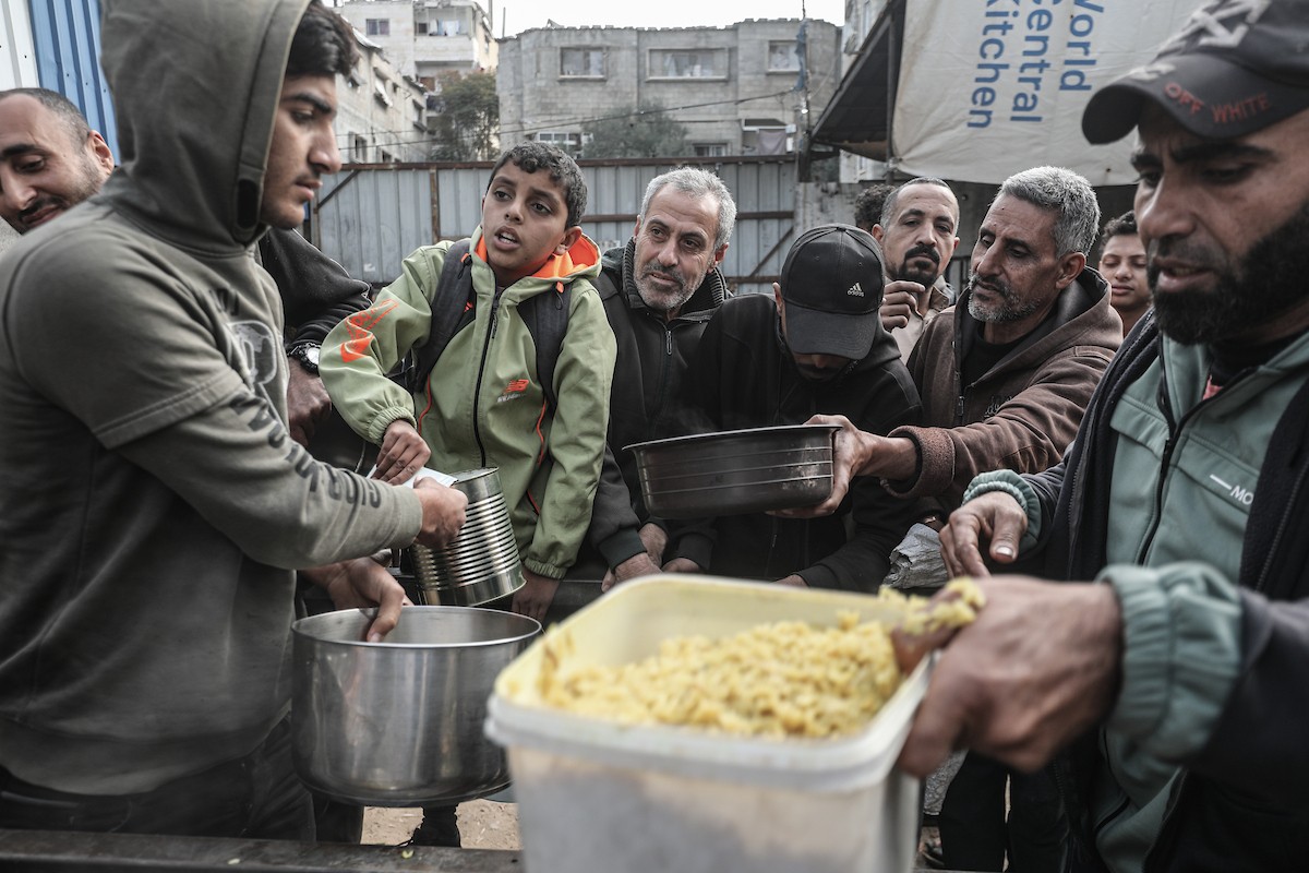 تجمع فلسطينيون نازحون داخلياً في مطبخ خيري لتلقي حصص غذائية محدودة وسط نقص حاد في الغذاء، في مخيم النصيرات للاجئين وسط قطاع غزة، 21 يناير/كانون الثاني 2026. صورة: معز صالحي